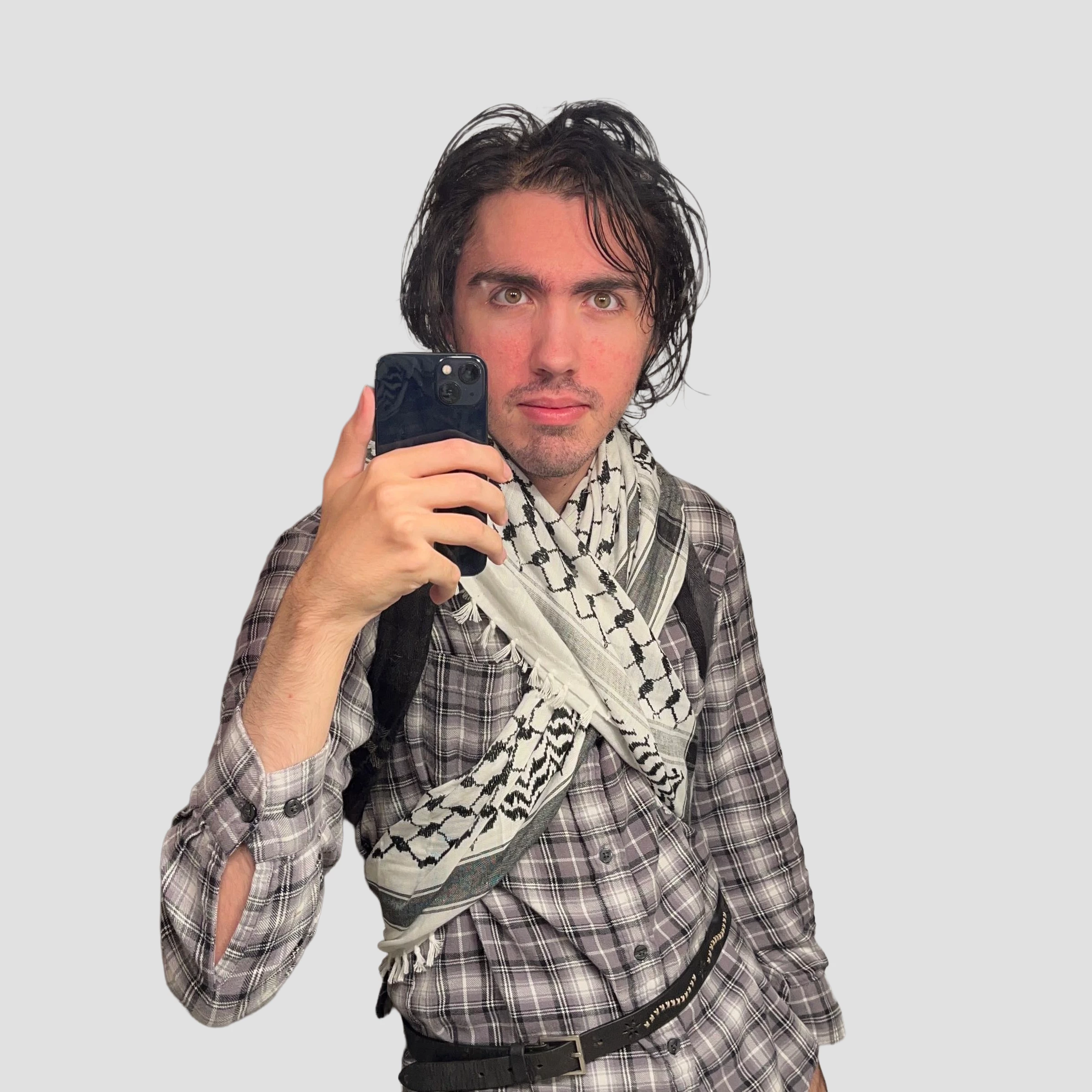 Xalsier standing in front of an edited white background, holding a phone.